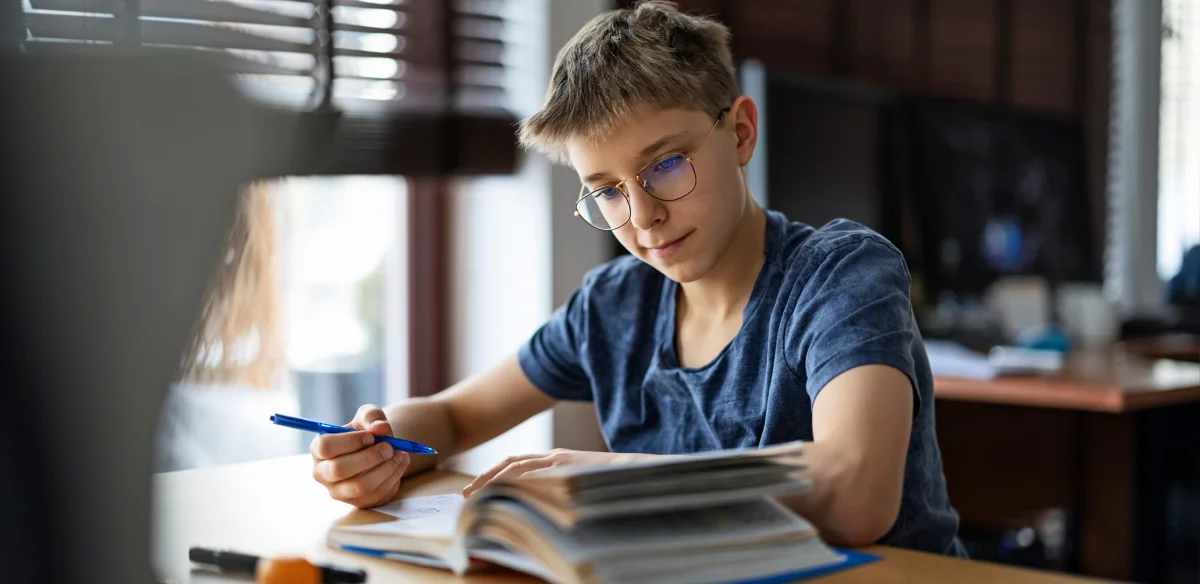 Middle school student taking notes