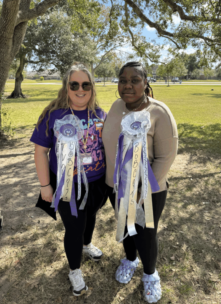 photo of two tvah staff members wearing homecoming mums made by parents