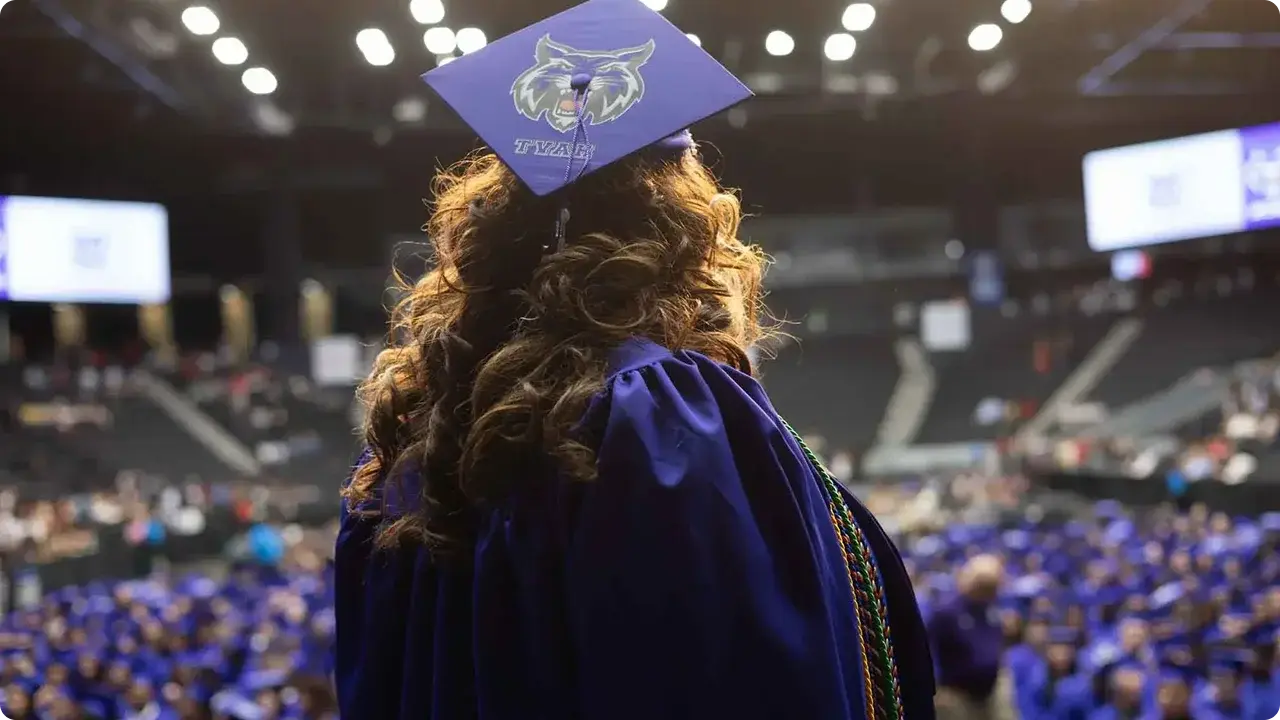 graduate looking out at audience of other graduates